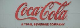 Image of Coca-Cola logo on outdoor signage, showing brand identity.
